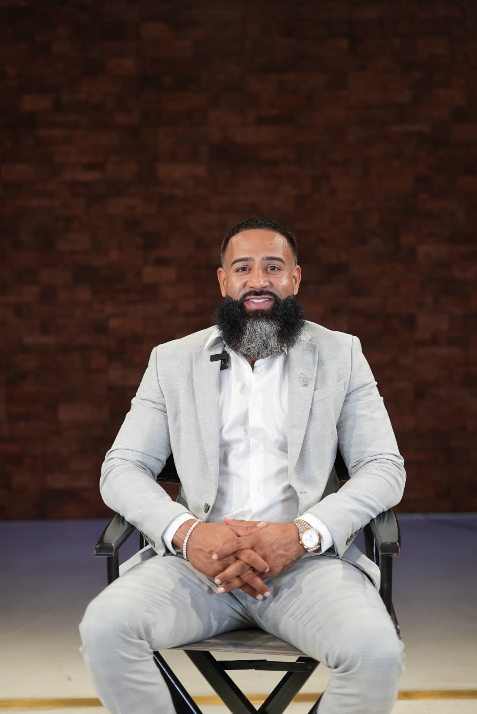 Xavier, the Relentless Credit Builder founder, in a tailored grey suit